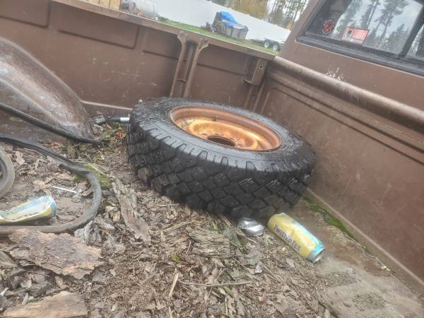 4 Cheap GOODYEAR studded snow tires mounted on 8 lug steel wheels
