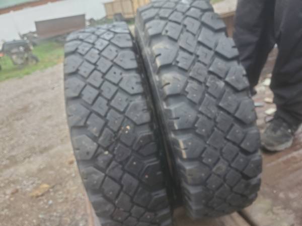 4 Cheap GOODYEAR studded snow tires mounted on 8 lug steel wheels